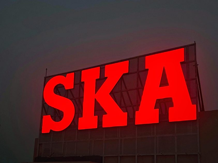 The same rooftop letters after dark — internally lit acrylic faces giving an even glow with no hot spots.