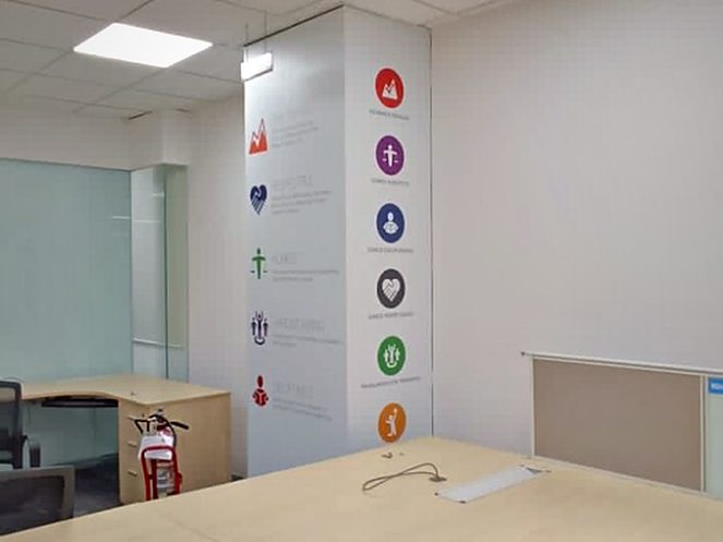 Vertical icon strip applied to a structural column, turning a blank element into a wayfinding and brand cue.