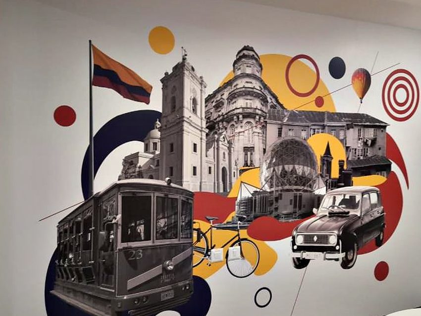 Large-format printed mural collaging city landmarks and transport into a single feature wall.
