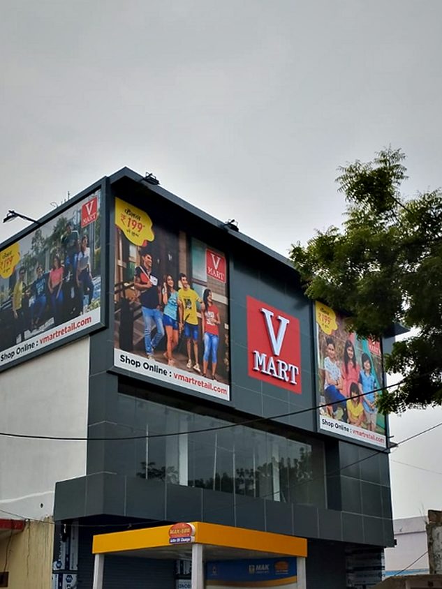 Full store elevation branding — fascia identity plus printed campaign panels across two retail levels.