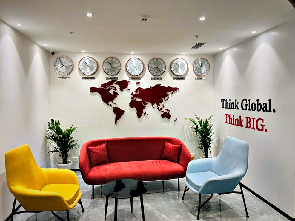 Reception feature wall combining a dimensional map, world clocks and a brand statement in one composition.