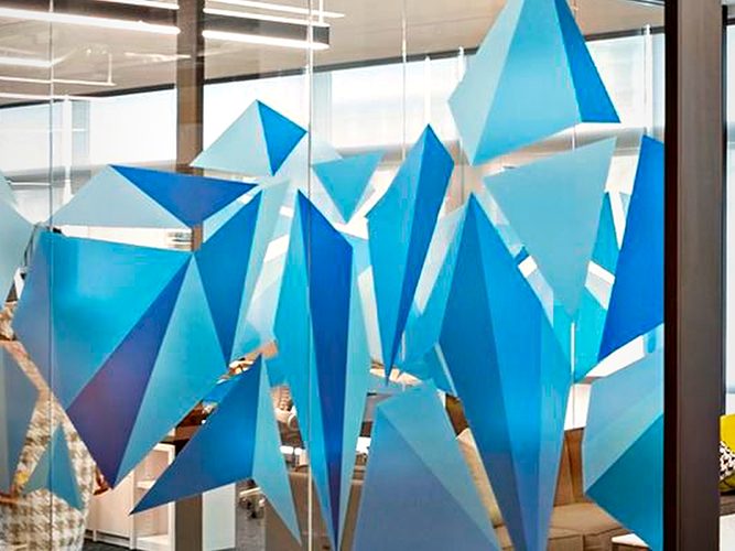 Faceted three-dimensional feature installation used as the focal point behind a glazed display frontage.
