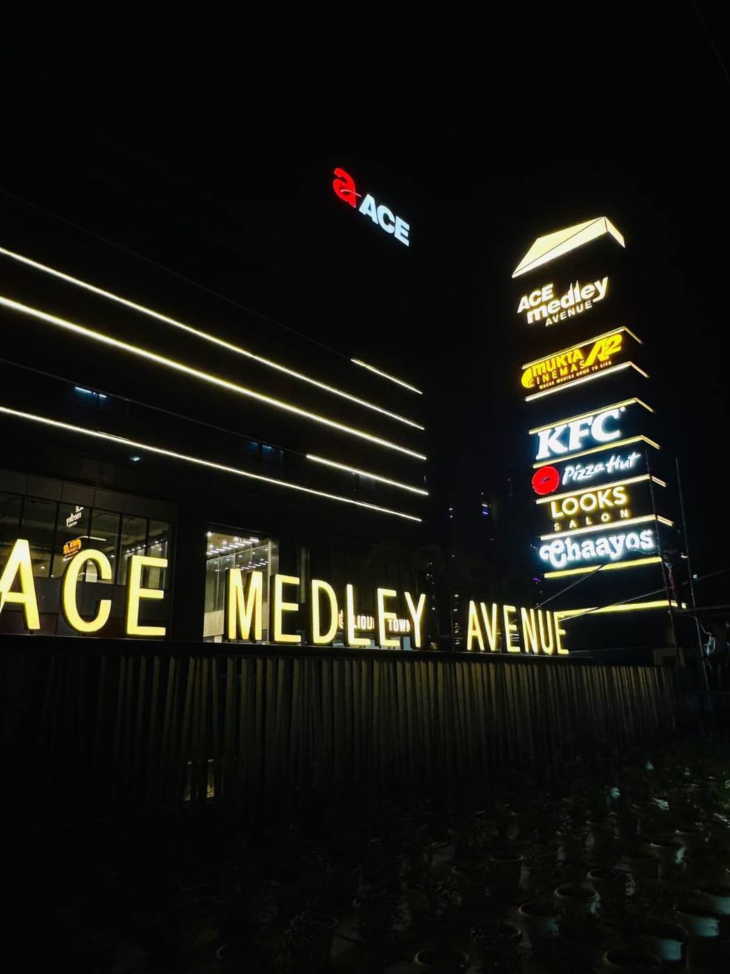 Illuminated multi-tenant identification pylon for ACE Medley Avenue, with backlit acrylic faces engineered for clear night-time visibility from the main road.