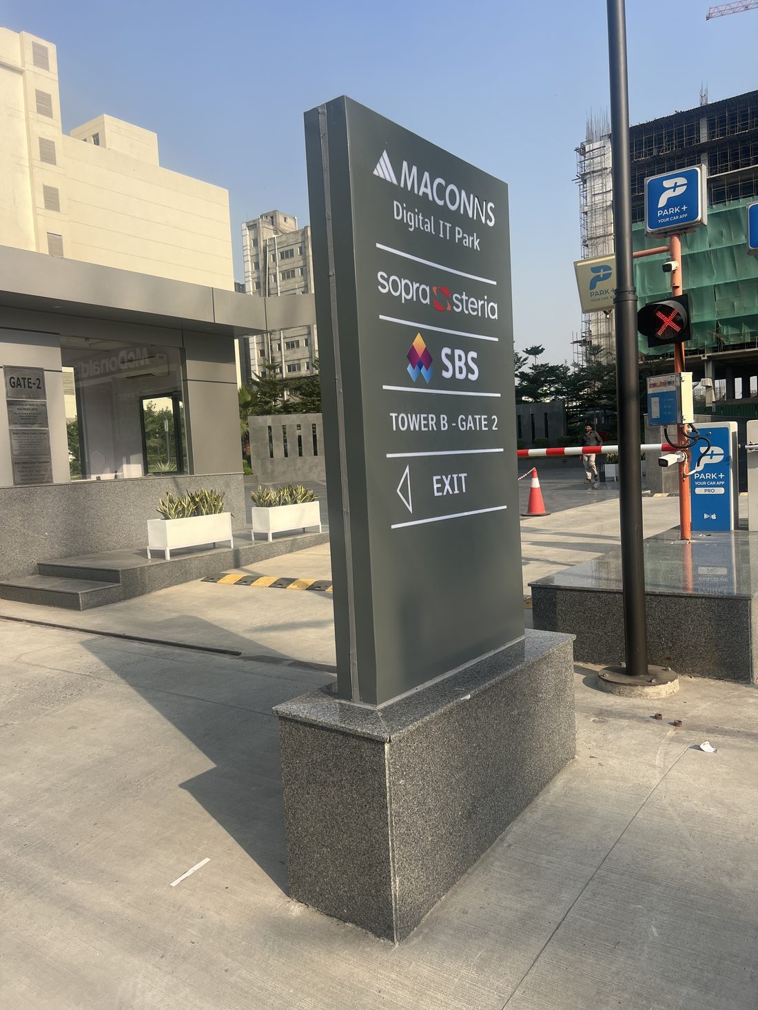 Directional pylon guiding traffic across the Maconns development to its towers, basement parking and sales office.