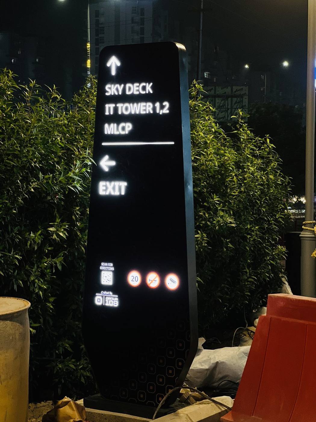Illuminated wayfinding totem for a corporate IT campus, routing visitors to the sky deck, towers, multi-level car park and exit.