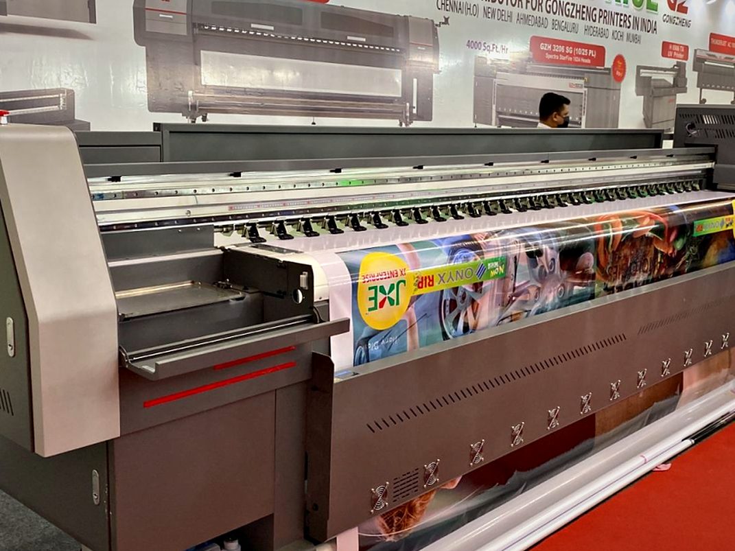 In-house wide-format UV printer running full-colour graphics for signage faces and campaign panels.